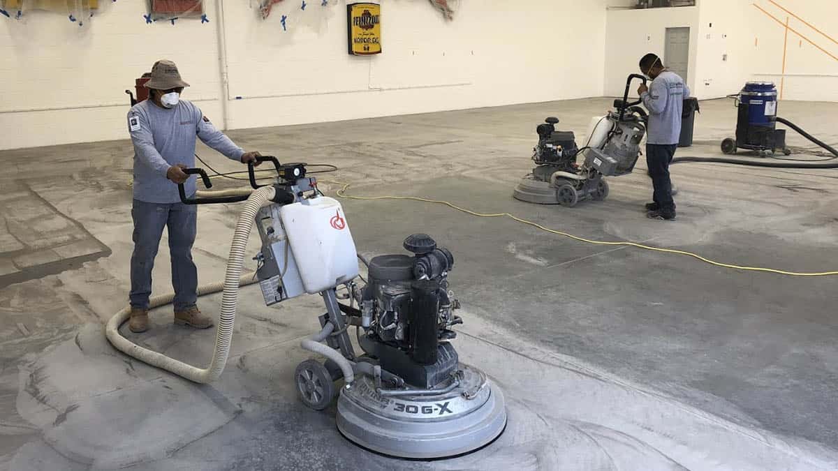 A concrete floor undergoing the grinding process